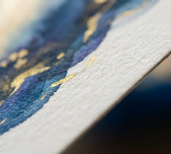 Gros plan sur la texture d'un papier couché mat haut de gamme sous éclairage naturel doux